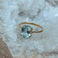 Nila - gold ring with oval blue topaz gemstone